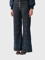Comfortable high-rise denim flares with unique hardware and embroidery, inspired by travels, from the Elsewhere Palace collection.