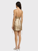 Elegant gold mini dress with delicate spaghetti straps, sculptural overlay, and a clean back zip closure for a chic look.