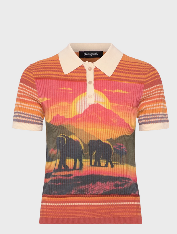  A woman wearing a polo shirt adorned with an elephant design, posing confidently in a casual setting.