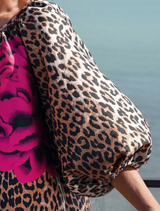 Feminine leopard floral dress with a keyhole neckline, puff sleeves, and side pockets, made from textured jacquard fabric.