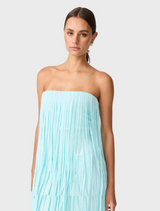 Strapless dress made of light blue fabric, embellished with fringes for a chic and modern look.