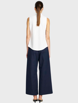 A pair of indigo suit pants hanging, featuring a sleek design and crisp lines, ideal for formal occasions.