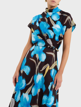 Ingrid midi dress in blue iris floral print, showcasing a stylish design with a fitted top and a flowing skirt for elegance.