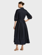 Sophisticated Olivia dress in deep ink, featuring a refined cut and flowing lines, perfect for upscale events.


