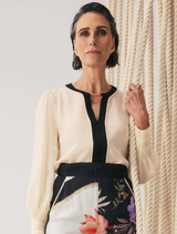 Elegant silk blouse in cloud color with pleated cuffs, showcasing a sophisticated and stylish design.