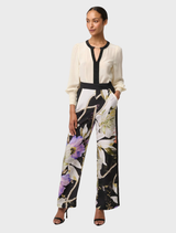 Luxurious silk blouse in a soft cloud hue, designed with stylish pleated cuffs for added elegance.