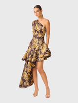 Midi dress in brown and gold floral jacquard, showcasing an asymmetrical neckline, one shoulder, and tiered high-low hem.