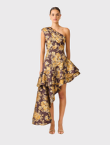 Brown and gold floral midi dress with asymmetrical neckline, one-shoulder design, and tiered high-low hem for fluid movement.