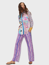 Vibrant Isabel shirt with Flower of Life design, mystical eye symbols, and bold text celebrating consciousness and energy.
