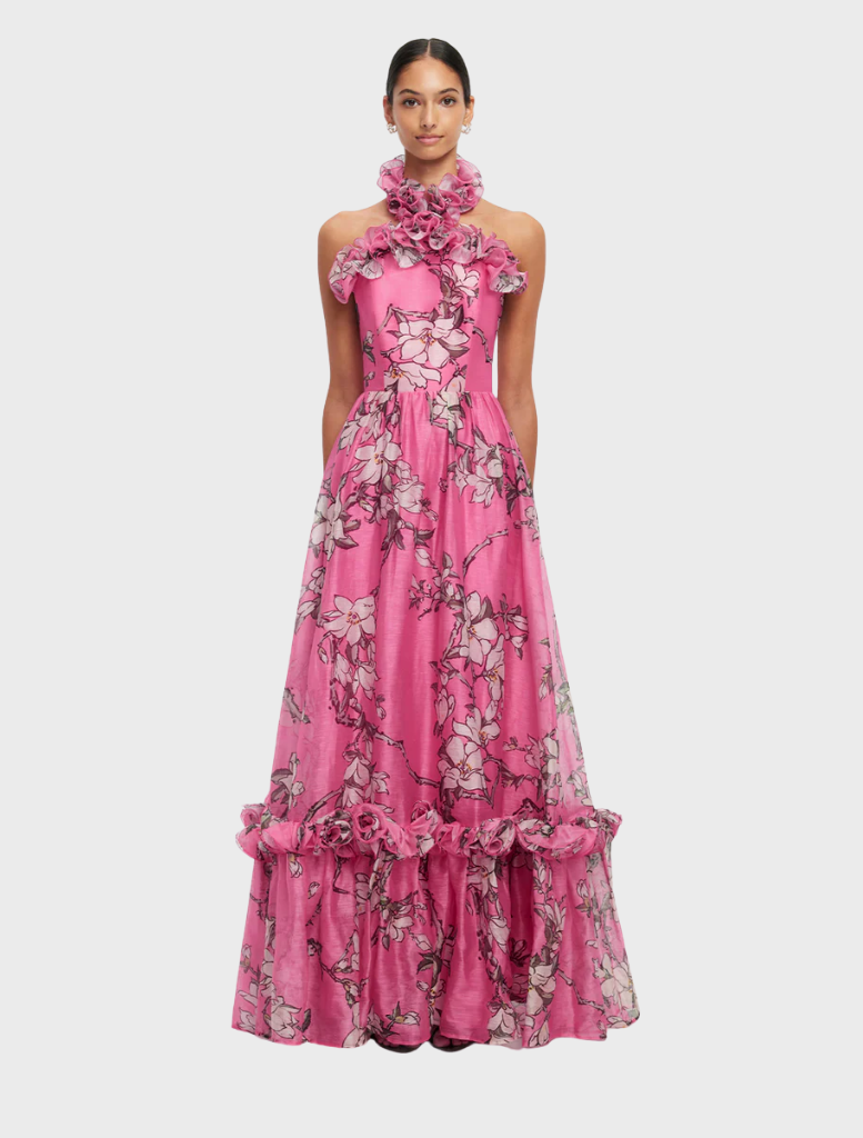 Pink magnolia print halterneck maxi dress with ruffled details, showcasing a feminine and elegant design.