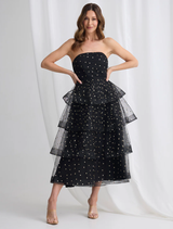 Black and gold Ivana tiered dress displayed on a mannequin, showcasing its elegant layers and stylish design.