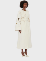 White wool coat with long sleeves and a belt, perfect for stylish warmth in cooler weather.