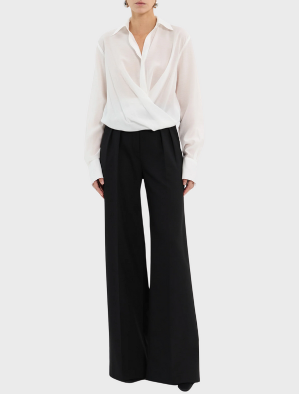 The image features an open white shirt with long sleeves, highlighting its casual style.