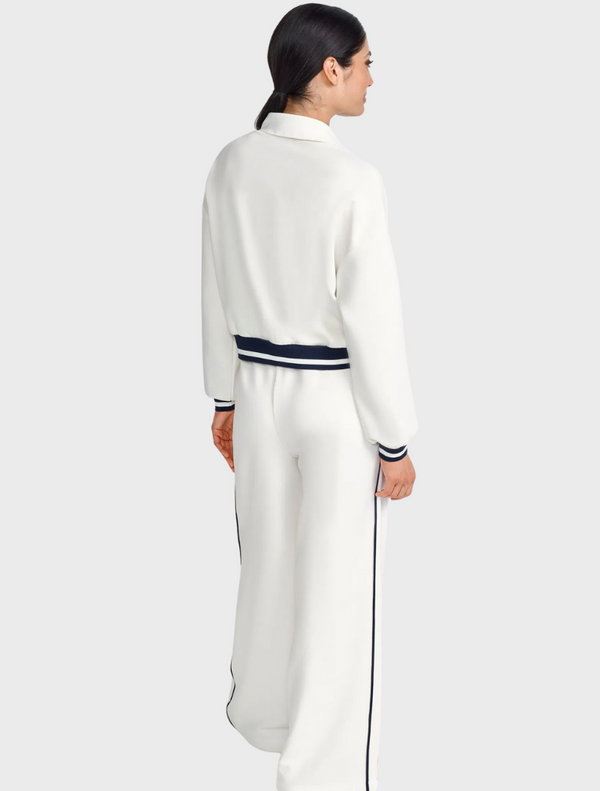 Women's white and navy tracksuit displayed on a mannequin against a neutral background.