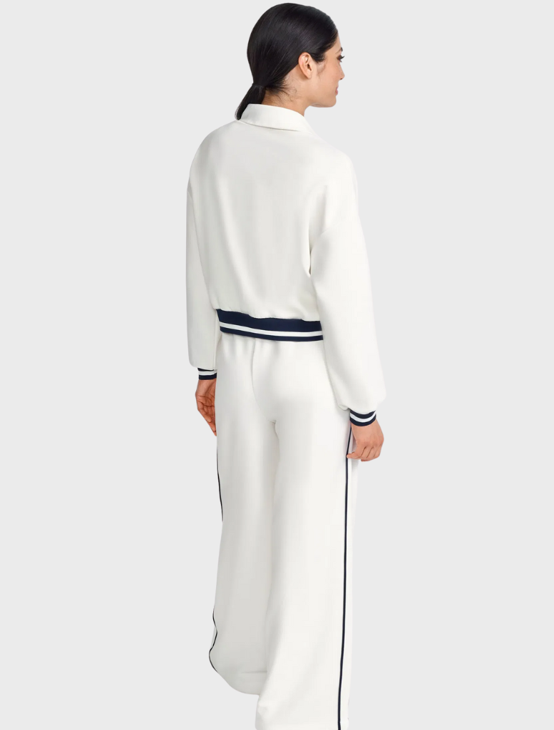 Women's white and navy tracksuit displayed on a mannequin against a neutral background.