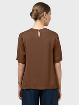 Stylish brown top with an asymmetric neckline, adding a modern touch to the outfit.
