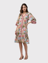 Knee-length dress with floaty sleeves, contrast front placket, and separate waist tie; features border print and tucks at neckline.