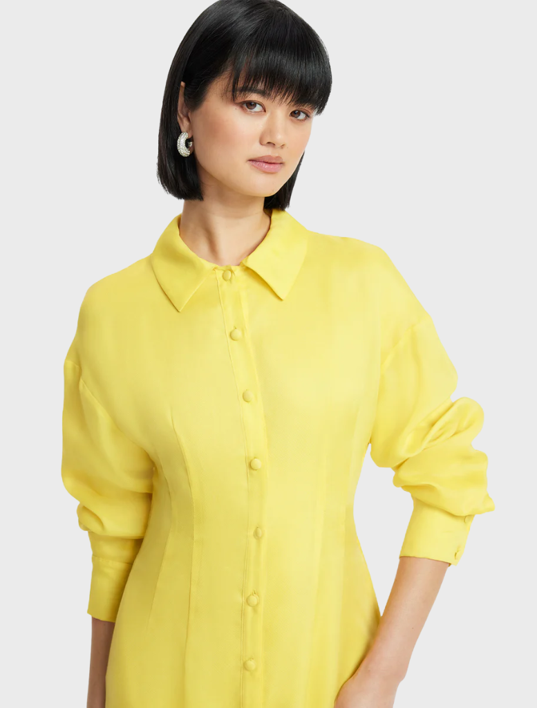 A lightweight yellow dress made from soft fabric, highlighting its gentle texture and bright color.