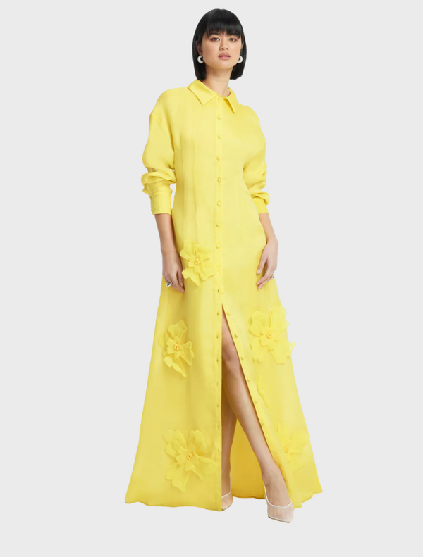 A soft, lightweight yellow dress drapes elegantly, showcasing its vibrant color and comfortable fabric.