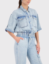 Versatile light denim jacket crafted from lyocell, showcasing a shirt collar, ¾ sleeves, and stylish patch pockets.
