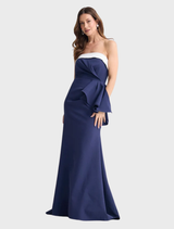 Navy and white striped Jefferson dress displayed on a hanger, showcasing its elegant design and fabric texture.