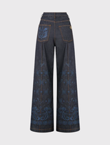 High-waisted denim flares with relaxed fit, custom hardware, and hand-embroidered patches from the Elsewhere Palace collection.
