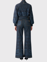 Relaxed high-waisted flare jeans featuring custom CAMILLA hardware and hand embroidery, inspired by Austrian journeys.
