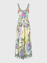 Sleeveless maxi dress with a belted waist, adorned with Chinoiserie prints, blending elegance and fluidity in design.
