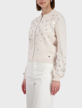 Chic champagne beige jacket with eye-catching jewelry elements, designed for a fashionable and refined look.