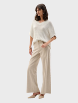 Women's v-neck tunic sweater made from soft, lightweight knit fabric.