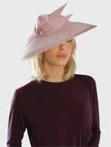 Josephine Fascinator in pink, showcasing a bow detail and sheer brim, secured on a headband for easy and comfortable wear.