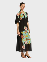 Black floral print dress styled with sandals, featuring the Julia Maxi Dark Ink Floral design.
