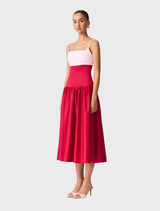 The dress is a June gown, featuring a white upper section and a red and pink lower half.