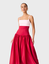 A stylish June gown with a white top and a vibrant red and pink skirt design.
