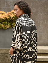 Black and stone casual shirt draped on a mannequin, highlighting its contemporary style and comfortable fabric.