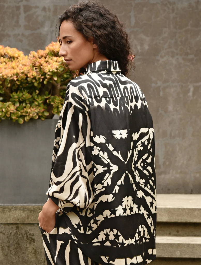 Black and stone casual shirt draped on a mannequin, highlighting its contemporary style and comfortable fabric.