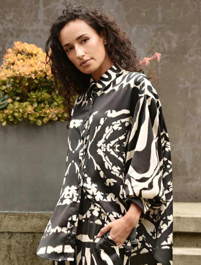 Black and stone casual shirt displayed on a hanger, showcasing a relaxed fit and modern design.