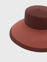 Rose pink Kartia Racewear Droop Hat with structured shape and contrasting details, featuring an internal cord for secure styling.