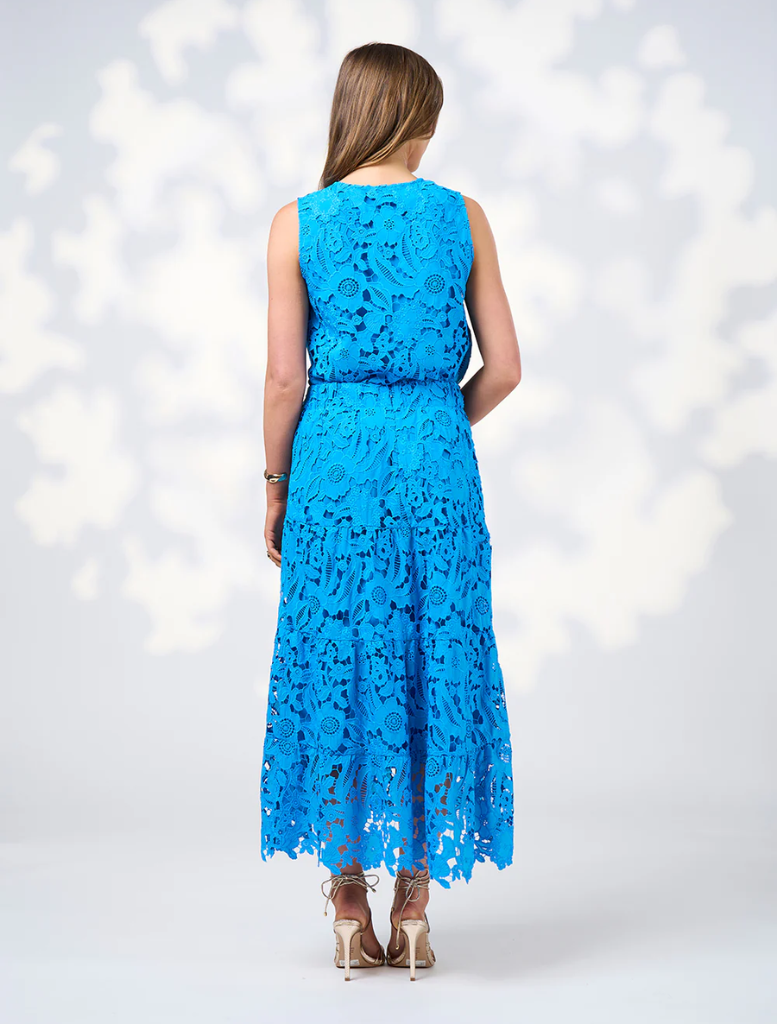 The model wears a Baja Blue lace dress with a belt, highlighting the elegant design of the Keira Skirt.