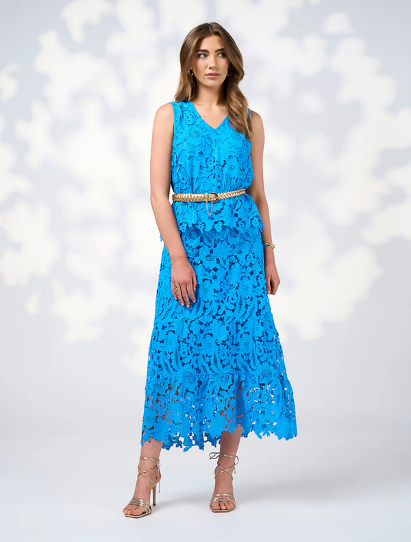 Model in a blue lace dress with a belt, showcasing the Keira Skirt in Baja Blue.