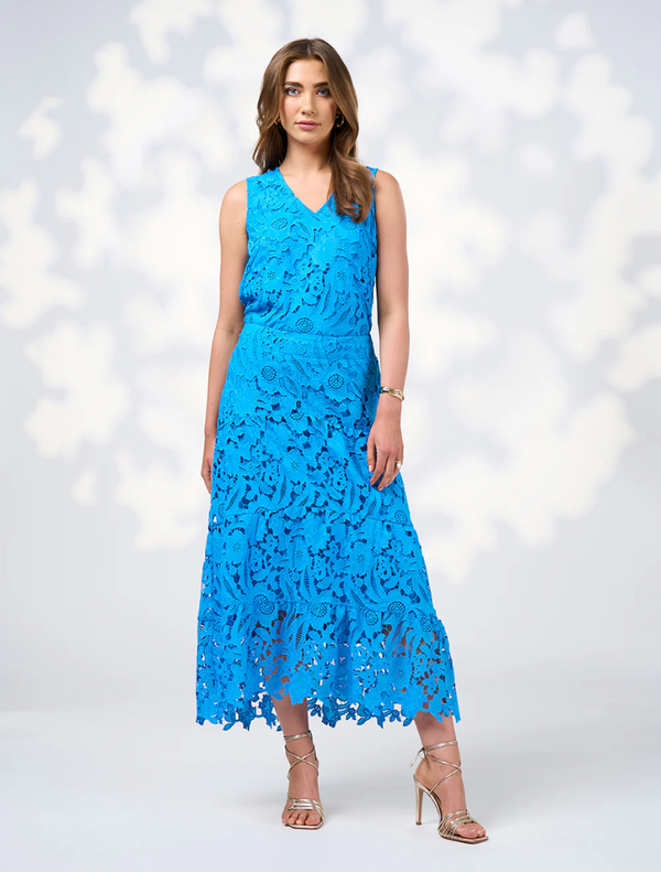 Model wearing a blue lace dress named Keira Top in Baja Blue, showcasing intricate lace details and a stylish silhouette.
