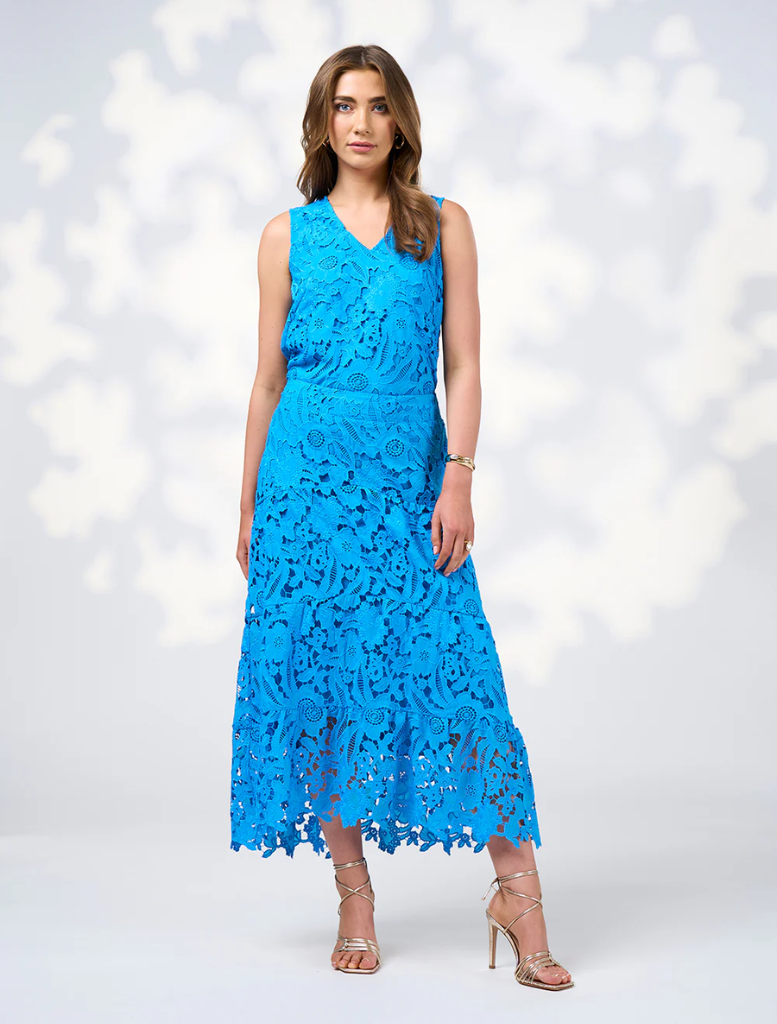 Model wearing a blue lace dress named Keira Top in Baja Blue, showcasing intricate lace details and a stylish silhouette.