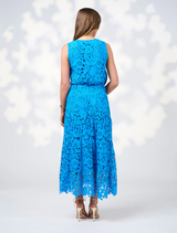 Model wearing a blue lace dress named Keira Top in Baja Blue, show back side of top
