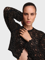 A black Kenny jacket presented on a hanger, emphasizing its elegant design and suitability for diverse fashion contexts.