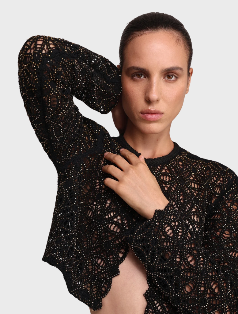 A black Kenny jacket presented on a hanger, emphasizing its elegant design and suitability for diverse fashion contexts.