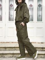 A pair of khaki found objects pants laid flat, highlighting the fabric and stitching details.