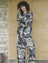 Black kick pleat pants with a tailored fit, featuring a stylish pleat detail for added elegance and movement.