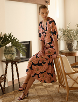 A pink midi dress named Kimberly Midi, featuring a stylish design and elegant silhouette, perfect for various occasions.