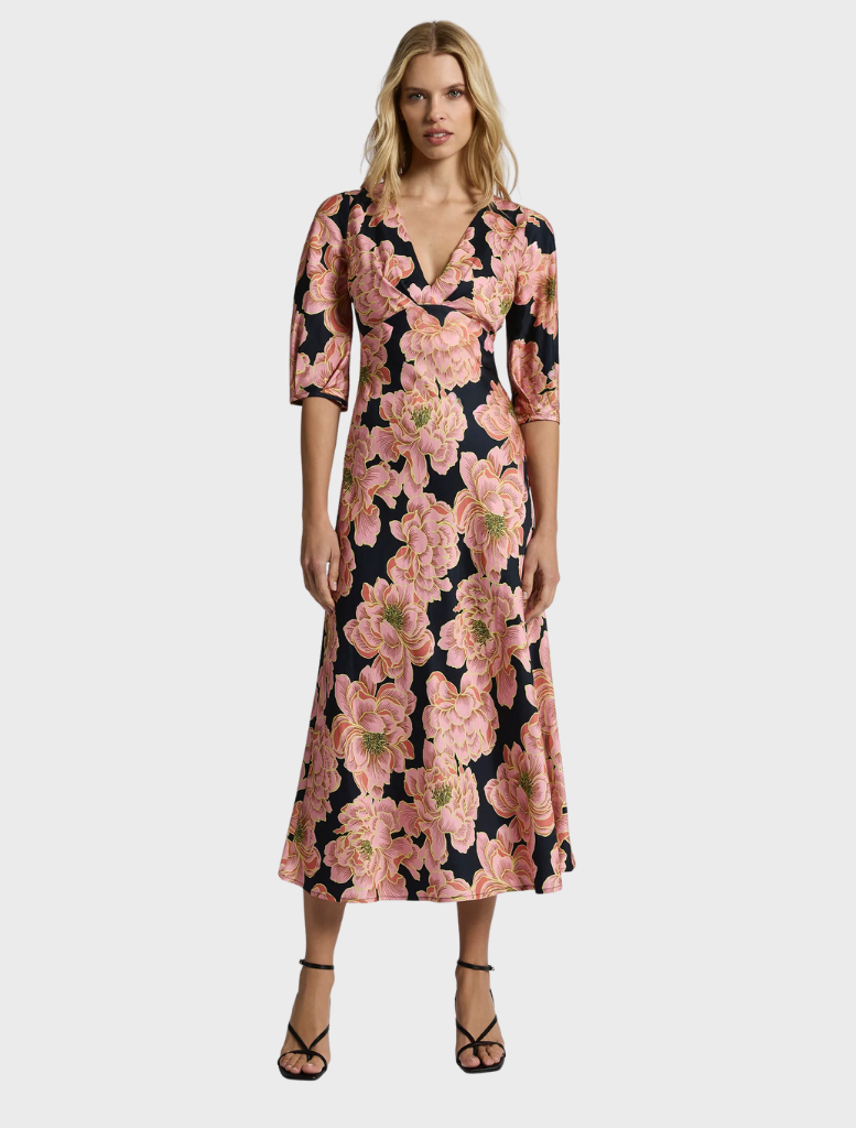 A fashionable pink midi dress called Kimberly Midi, designed to offer elegance and versatility for different occasions.