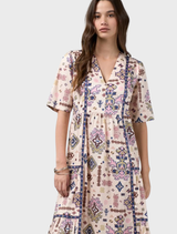 Printed midi dress in bone multi with gathered tiers, flat front panel, and contrast piping; elasticated back waist.